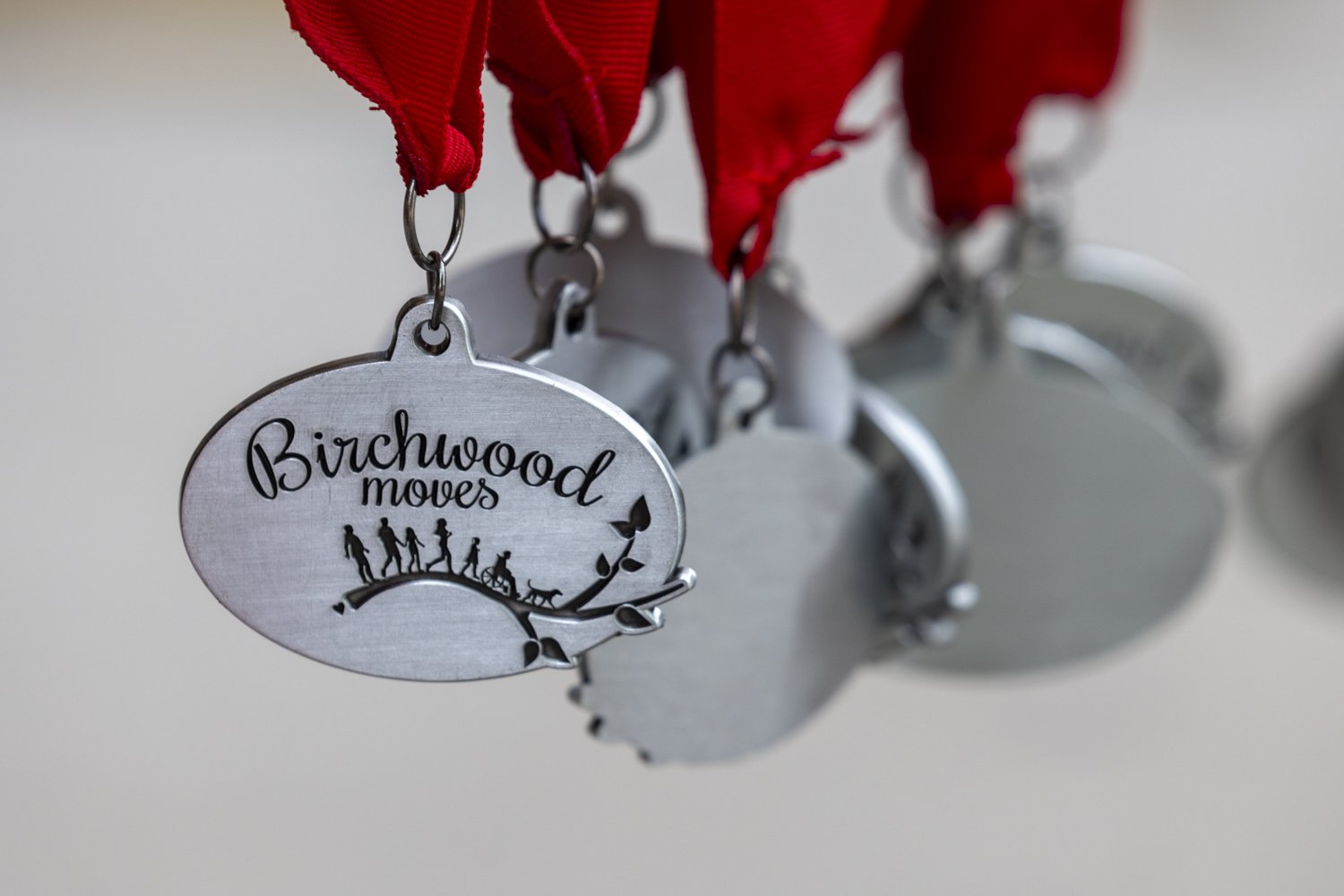 Silver medals with "Birchwood Moves" text and red ribbons.