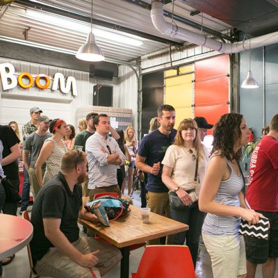 Group of people gathered in an indoor space with industrial design