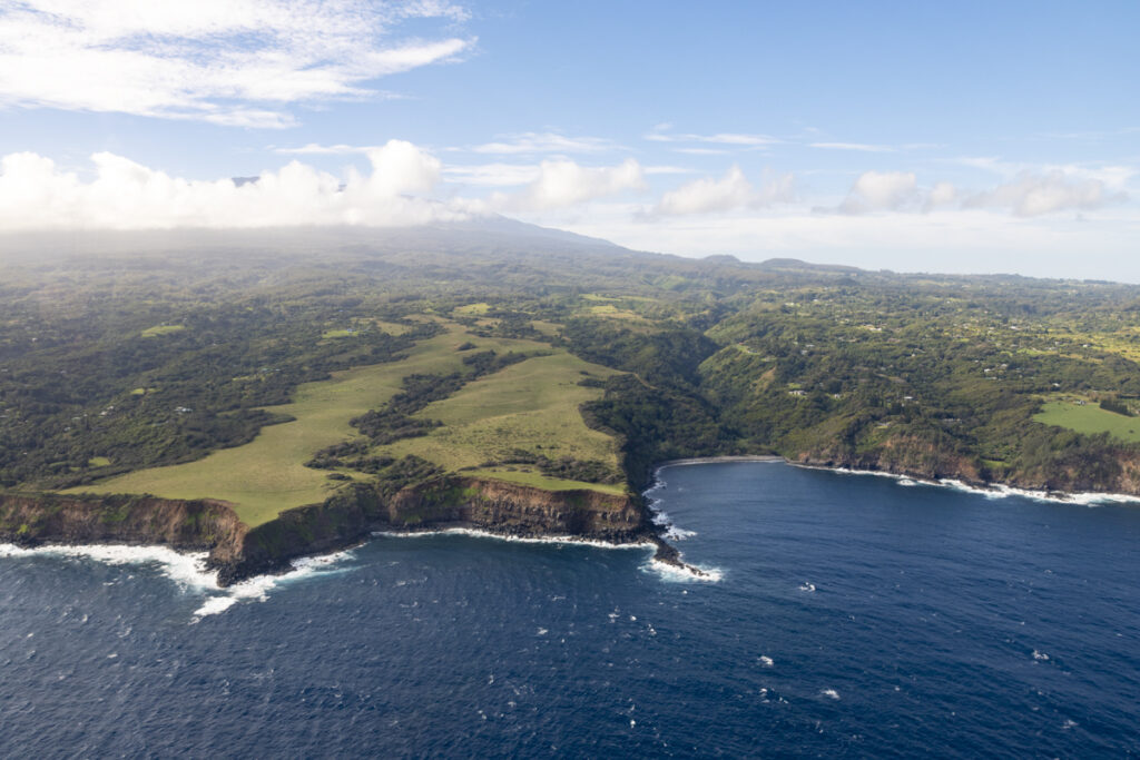 Aerial view of Maui north shore jagged sea cliffs and deep blue Pacific Ocean